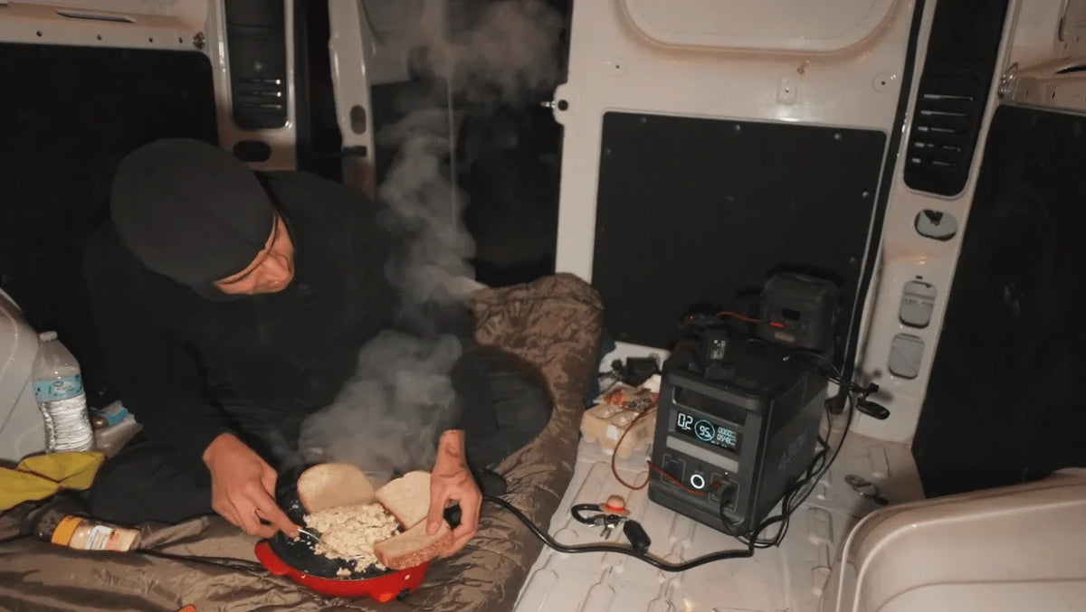 ABOK portable power station powering cooking equipment inside a vehicle.