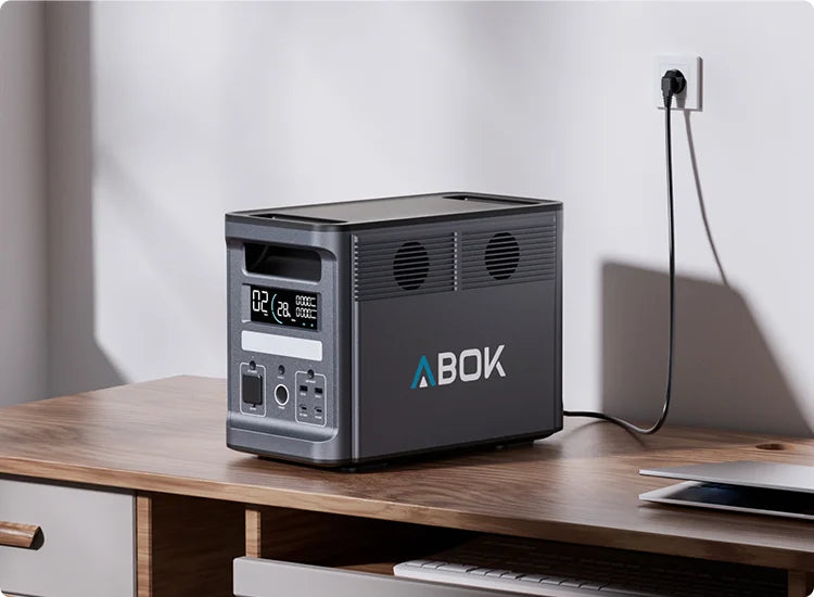 ABOK Ark2000 mobile home scene showing the EU-spec power station connected to a wall outlet for an 80-minute full charge.