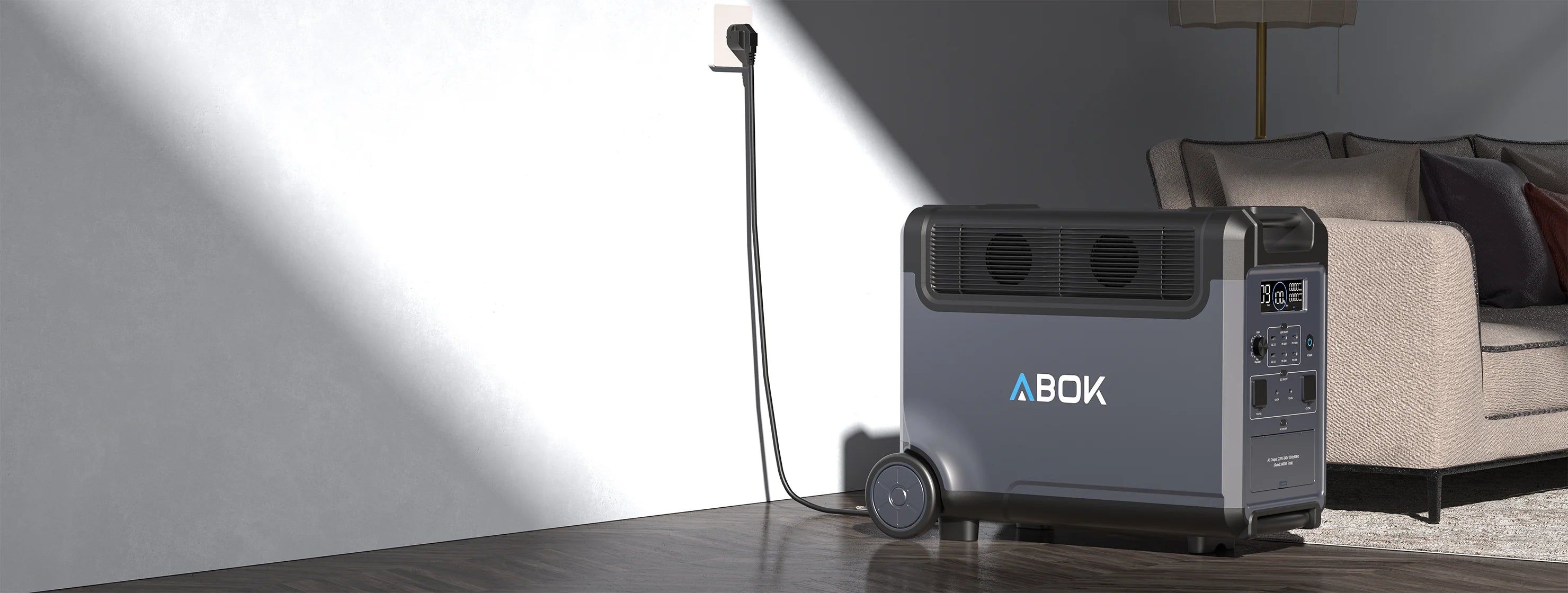 ABOK Ark3600 EU-spec home backup setup beside a sofa with the power station connected to a wall outlet.